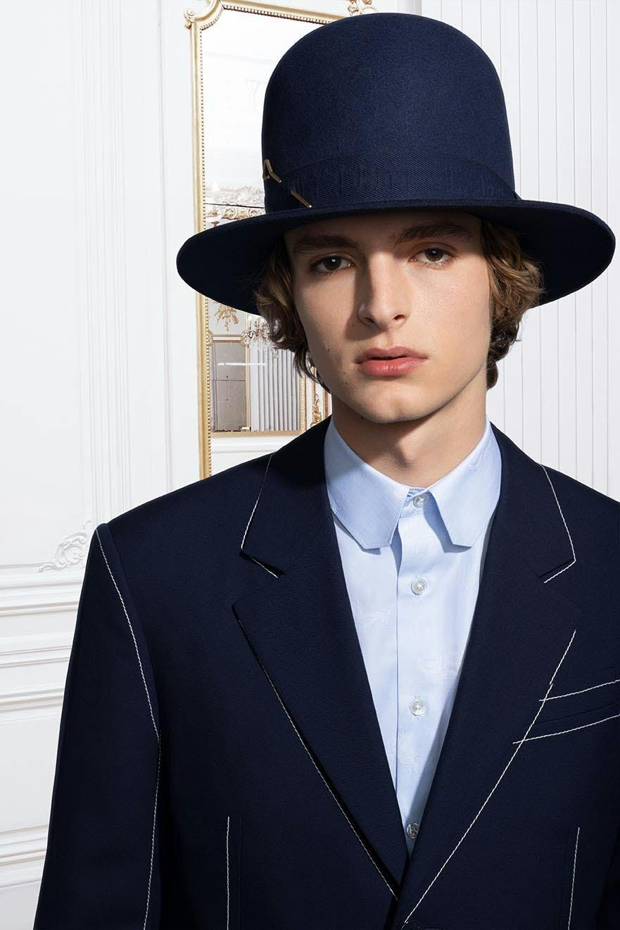clothing apparel person human suit coat overcoat hat sun hat