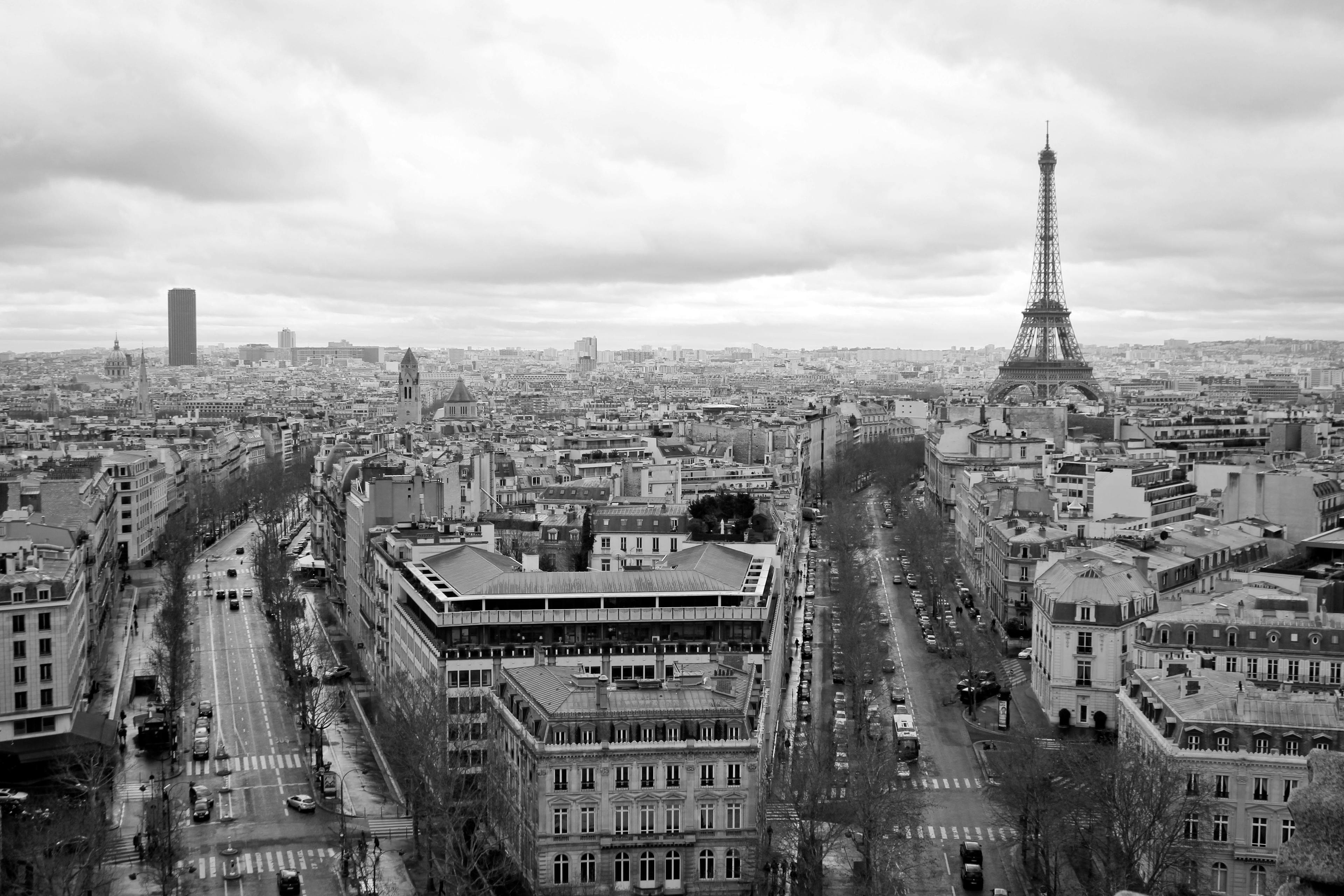 eiffel tower,sky,city life,city,roads,tourism,traveling,view,paris,showplace,street,buildings,france,black and white,europe,architecture,tower metropolis city urban intersection road spire tower cityscape outdoors office building