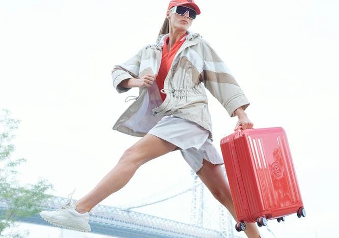 Woman with Bogner hard shell suit case