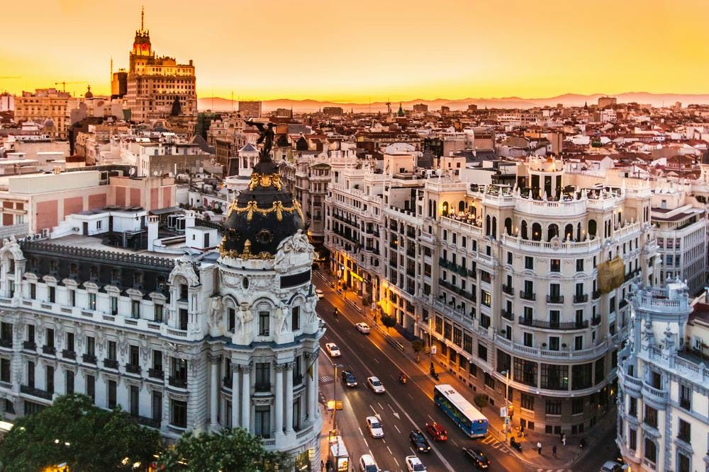 symbol,gran via,dusk,historical,aerial,building,scene,beautiful,view,cityscape,landmark,tower,traffic,sky,metropolis,old,downtown,skyscraper,square,warm,panorama,light,madrid,spain,color,city,tourism,monument,skyline,world,modern,top,street,terrace,place,europe,architecture,roof,spanish,famous,sculpture,orange,outdoor,urban,sunset,illuminated,evening,travel,landscape city metropolis urban building cityscape downtown road intersection outdoors car