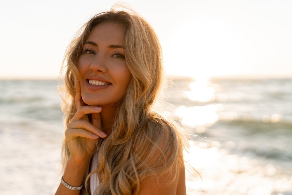 Blond woman with beach waves on the sea
