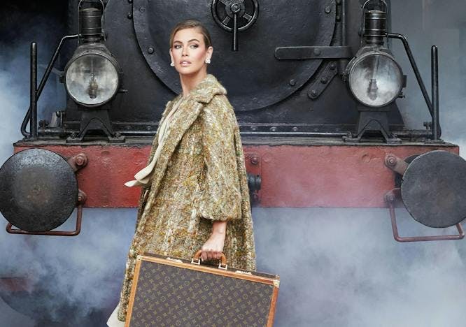 adult female person woman coat handbag ice hockey puck train locomotive dress