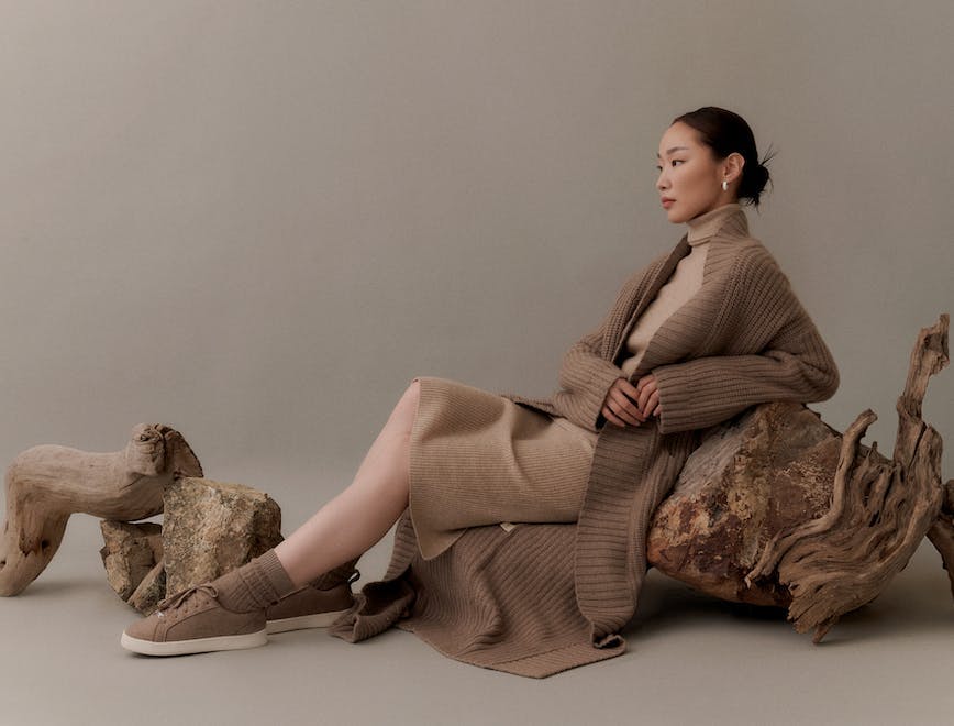 campaign 2022 adult female formal wear knitwear person shoe sitting sweater woman wood